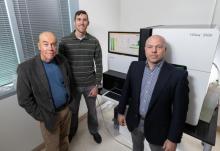 Researchers with sequencing equipment